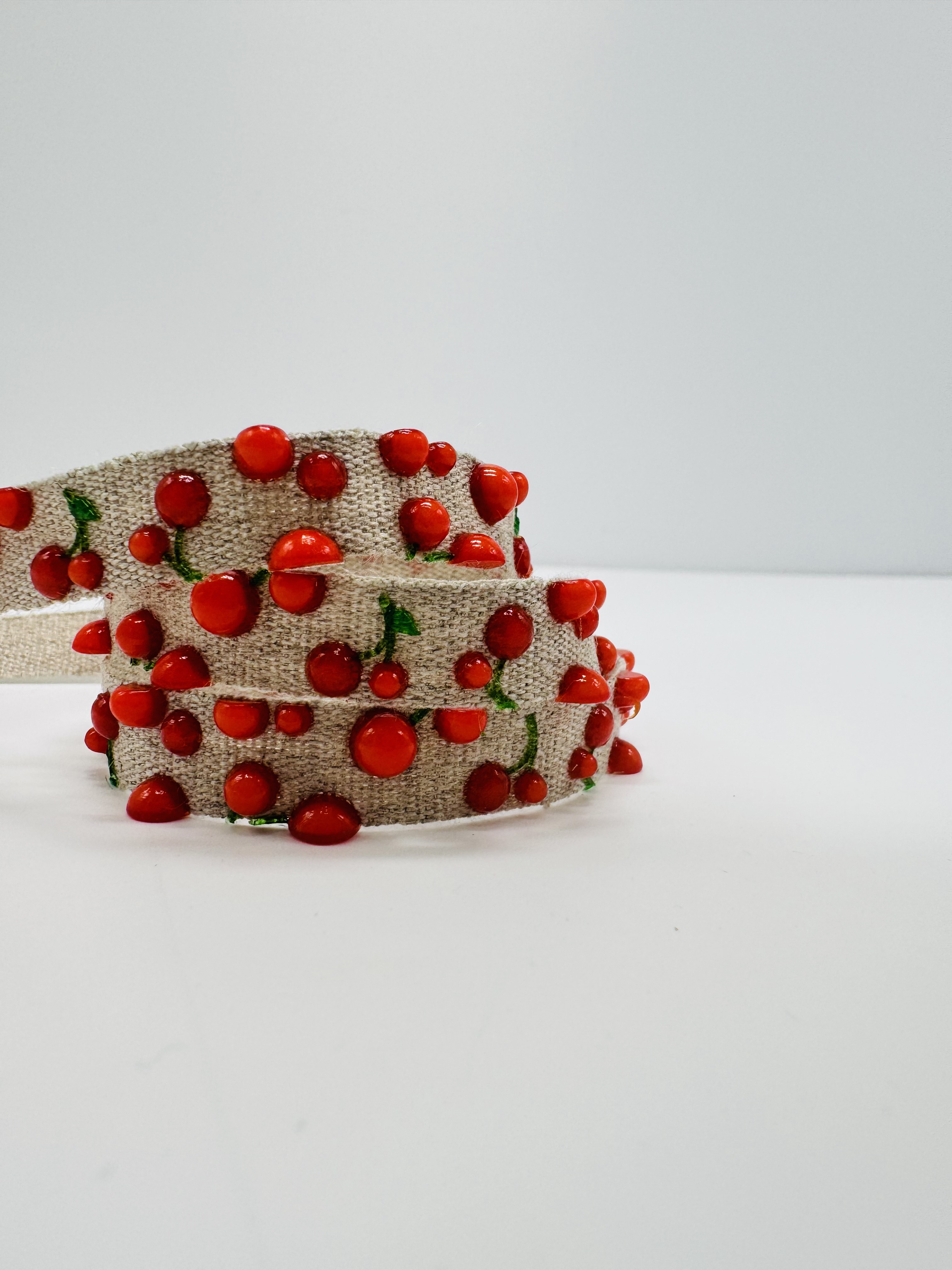 3D printed cherry patterns on narrow fabric by Satab.